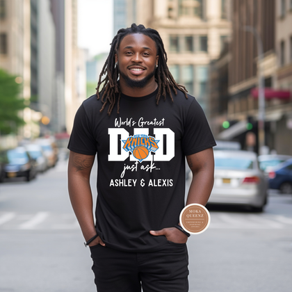 Man wearing a black t-shirt with 'World's Greatest Dad' text on a city street