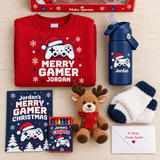 Merry Gamer Christmas gift box contents: red personalized sweatshirt, Jordan navy tumbler, activity book, crayons, reindeer plush, cozy socks, and Santa note