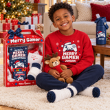 Smiling little boy in a red Merry Gamer sweatshirt sitting beside his personalized Christmas gift box