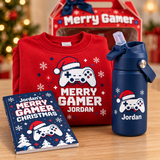 Close-up of Merry Gamer personalized red sweatshirt, Jordan navy tumbler, and Merry Gamer Christmas activity book