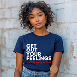Woman wearing a navy blue t-shirt with text against a textured wall.
