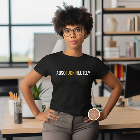 Person wearing a black t-shirt with text in an office setting
