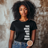 Woman wearing a black t-shirt with motivational text against a textured wall.