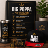 Collection of 'BIG POPPA' themed merchandise including a framed poster, tumbler, cap, keychain, and card on a wooden surface.