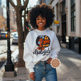 Woman wearing a white sweatshirt with a graphic design and text on a city street.