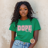 Woman wearing a green t-shirt with 'DOPE' printed on it against a beige wall.
