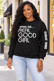 A woman wearing a black crewneck sweatshirt with white text reading 'SPECIAL GIRL.