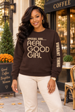A woman wearing a dark brown crewneck sweatshirt with the text 'SPECIAL GIRL.