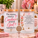 Two frosted glass mugs with bamboo lids and metal straws, displayed side by side on a marble surface. The left mug features the text 'The enemy tried it.