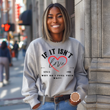 Woman wearing a gray sweatshirt with a heart design and text on a city street.