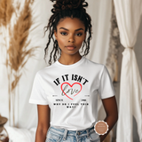 Person wearing a white t-shirt with a heart and text design, standing in a softly blurred indoor setting.