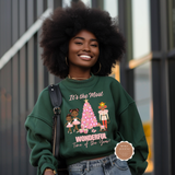 Woman wearing a green sweatshirt with a Christmas design, standing outdoors.