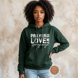 Prayer Is My Love Language hoodie in forest green with distressed white typography, modeled