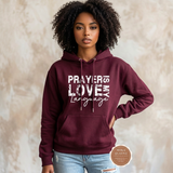 Prayer Is My Love Language hoodie in maroon with distressed white typography, modeled
