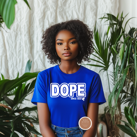 Person wearing a blue 'DOPE' t-shirt with plants in the background