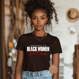 Woman wearing a brown t-shirt with text, standing in a casual setting.