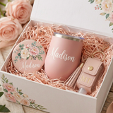 Close-up of the personalized pink Madison tumbler, floral pocket mirror, and blush leather initials sanitizer holder with tassel in the gift box
