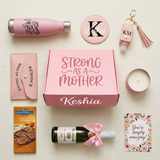 Strong As A Mother personalized gift box flat lay with the water bottle, mirror, pouch, keychain, candle, Ghirardelli bar, mini cider, and postcard