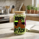 100% That B*tch graphic glass filled with iced matcha latte, with illustrated Black woman, bamboo lid and glass straw.