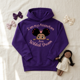 Purple I Am My Ancestors Wildest Dream girls hoodie flat lay with satin bows and a rag doll