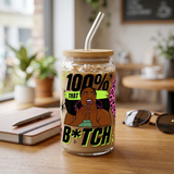 100% That B*tch iced coffee glass with illustrated woman and lime and pink accents on a cafe table.