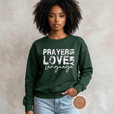 Prayer Is My Love Language sweatshirt in forest green with distressed white typography, modeled