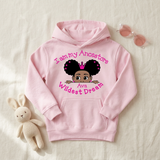 Light pink I Am My Ancestors Wildest Dream girls hoodie flat lay with a stuffed bunny and sunglasses