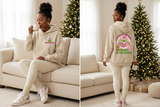 Beige Grinchmas hoodie front-and-back lifestyle views with coordinated sneakers and hot cocoa.