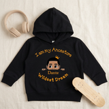 Black I Am My Ancestors Wildest Dream toddler boy hoodie flat lay with a skateboard and headphones
