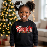 Toddler girl wearing a black personalized Christmas sweatshirt with the name Madison in embroidered-look patch letters