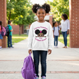 Smiling Black girl holding her backpack at school wearing a white I Am My Ancestors Wildest Dream sweatshirt with the name Ava