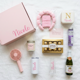 Spa Day personalized gift box flat lay with the Nicole box, spa headband set, jewelry case, bath salts, candle, Ferrero Rocher 8-pack, fan, tumbler, flute, mini cider, and note card