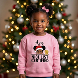 Toddler girl wearing a light pink personalized Christmas sweatshirt with the name Ava above the words Nice List Certified