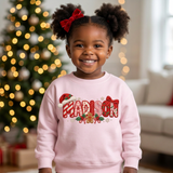 Toddler girl wearing a light pink personalized Christmas sweatshirt with the name Madison in embroidered-look patch letters