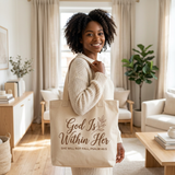 Smiling Black woman with the God Is Within Her tote bag on her shoulder in a bright living room