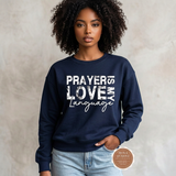 Prayer Is My Love Language sweatshirt in navy blue with distressed white typography, modeled