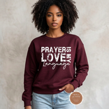 Prayer Is My Love Language sweatshirt in maroon with distressed white typography, modeled