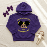 Purple I Am My Ancestors Wildest Dream toddler girl hoodie flat lay with satin bows and a doll