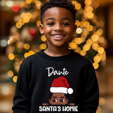 Toddler boy wearing a black personalized Christmas sweatshirt with the name Dante above the words Santa's Homie