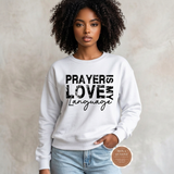 Prayer Is My Love Language sweatshirt in white with distressed black typography, modeled